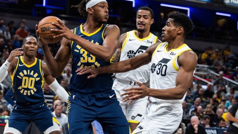 Nov 8, 2023; Indianapolis, Indiana, USA; Indiana Pacers center Myles Turner (33) rebounds the ball while Utah Jazz guard Ochai Agbaji (30) defends in the first quarter at Gainbridge Fieldhouse. Mandatory Credit: Trevor Ruszkowski-USA TODAY Sports