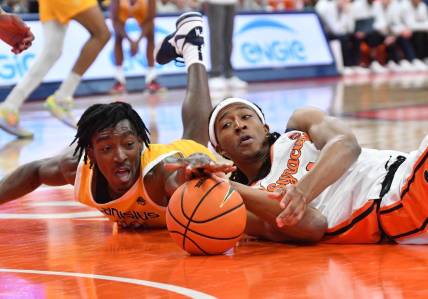 Nov 8, 2023; Syracuse, New York, USA; Canisius Golden Griffins forward Bryce Okpoh (left) and Syracuse Orange forward Maliq Brown reach for a loose ball in the first half at the JMA Wireless Dome. Mandatory Credit: Mark Konezny-USA TODAY Sports