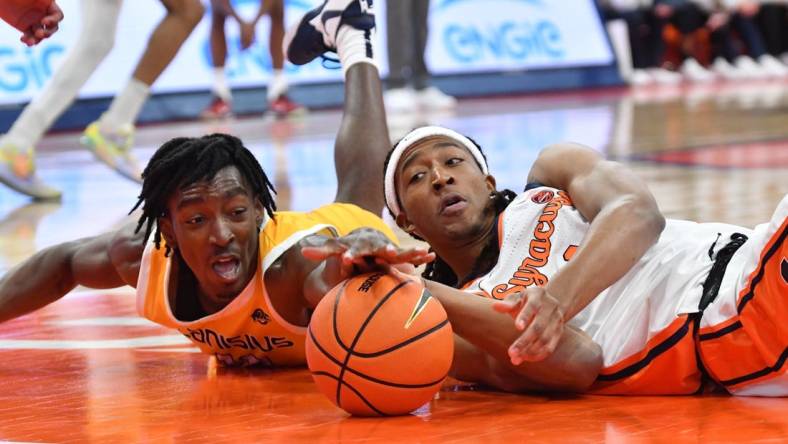 Nov 8, 2023; Syracuse, New York, USA; Canisius Golden Griffins forward Bryce Okpoh (left) and Syracuse Orange forward Maliq Brown reach for a loose ball in the first half at the JMA Wireless Dome. Mandatory Credit: Mark Konezny-USA TODAY Sports