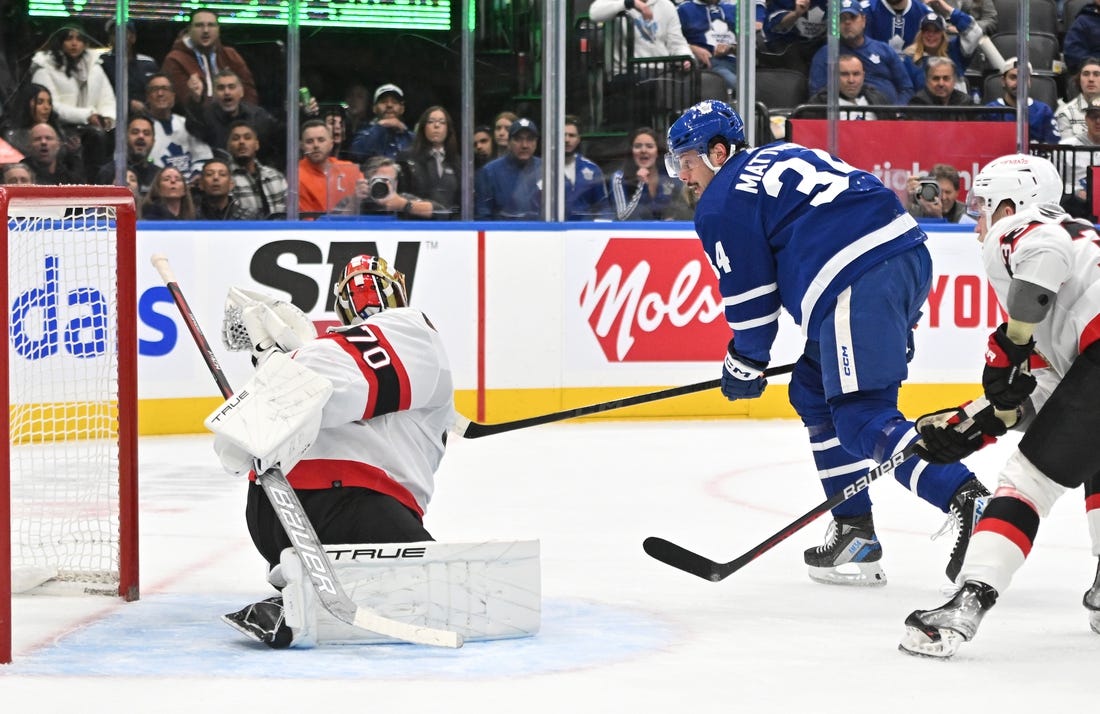 Nov 8, 2023; Toronto, Ontario, CAN; Ottawa Senators goalie Joonas Korpisalo (70) makes a glove save on Toronto Maple Leafs forward Auston Matthews (34) in the first period at Scotiabank Arena. Mandatory Credit: Dan Hamilton-USA TODAY Sports