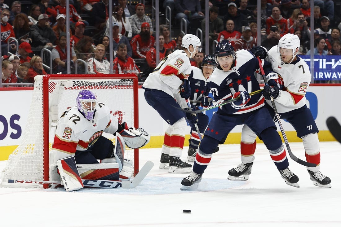 Nov 8, 2023; Washington, District of Columbia, USA; Washington Capitals right wing T.J. Oshie (77) and Florida Panthers defenseman Dmitry Kulikov (7) battle for the puck in front of Panthers goaltender Sergei Bobrovsky (72) in the first period at Capital One Arena. Mandatory Credit: Geoff Burke-USA TODAY Sports