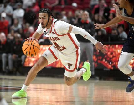 Texas Tech's guard Pop Isaacs (2) dribbles the ball against Texas A&M-Commerce in the first home game of the season, Wednesday, Nov. 8, 2023, at United Supermarkets Arena.