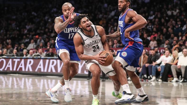 Nov 8, 2023; Brooklyn, New York, USA;  Brooklyn Nets guard Cam Thomas (24) is double teamed by LA Clippers forwards P.J. Tucker (17) and Kawhi Leonard (2) in the second quarter at Barclays Center. Mandatory Credit: Wendell Cruz-USA TODAY Sports