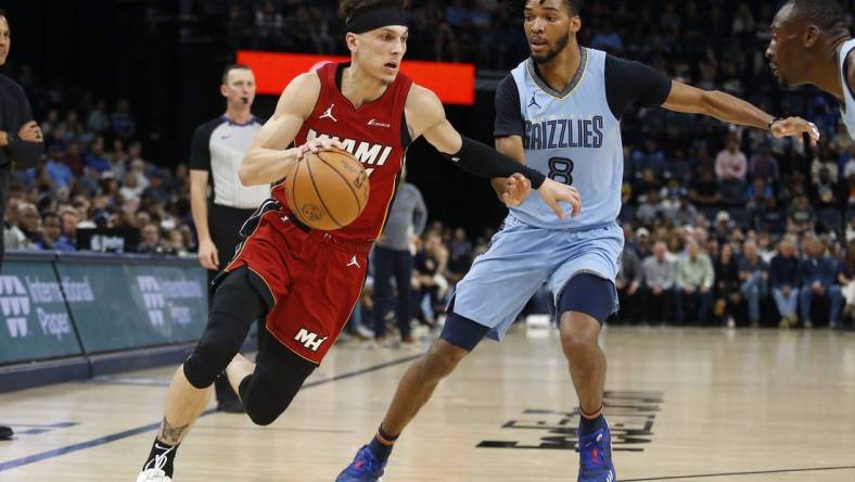 Nov 8, 2023; Memphis, Tennessee, USA; Miami Heat guard Tyler Herro (14) drives to the basket as Memphis Grizzlies forward Ziaire Williams (8) defends during the first half at FedExForum. Mandatory Credit: Petre Thomas-USA TODAY Sports