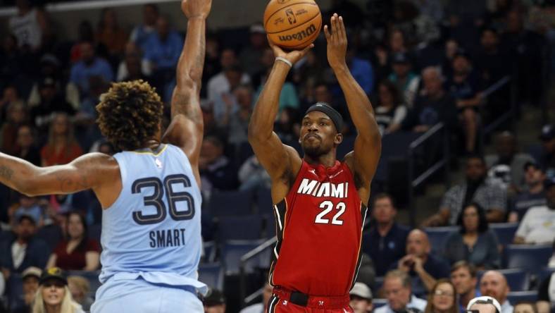 Nov 8, 2023; Memphis, Tennessee, USA; Miami Heat forward Jimmy Butler (22) shoots for three as Memphis Grizzlies guard Marcus Smart (36) defends during the first half at FedExForum. Mandatory Credit: Petre Thomas-USA TODAY Sports