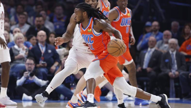 Nov 8, 2023; Oklahoma City, Oklahoma, USA; Oklahoma City Thunder guard Cason Wallace (22) drives to the basket around Cleveland Cavaliers guard Donovan Mitchell (45) during the second quarter at Paycom Center. Mandatory Credit: Alonzo Adams-USA TODAY Sports