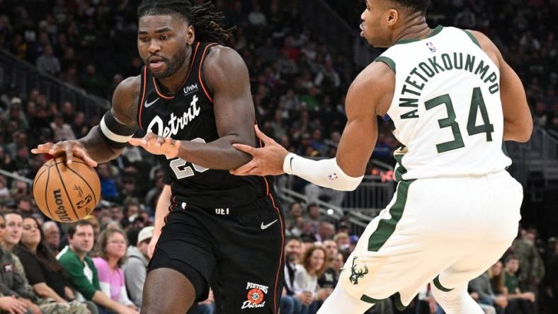 Nov 8, 2023; Milwaukee, Wisconsin, USA; Detroit Pistons guard Marcus Sasser (25) drives to the basket against Milwaukee Bucks forward Giannis Antetokounmpo (34) in the first half at Fiserv Forum. Mandatory Credit: Michael McLoone-USA TODAY Sports