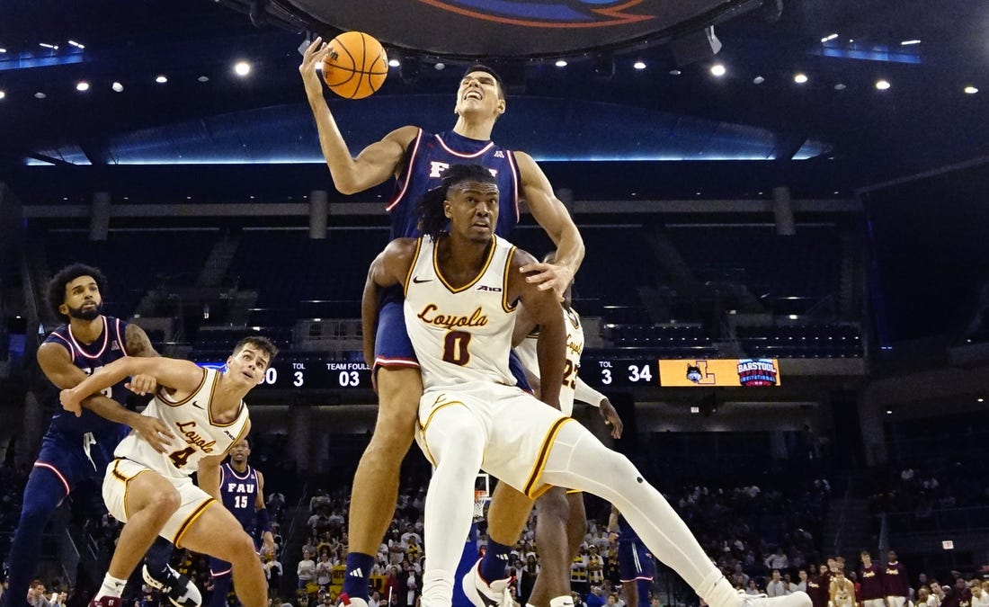 Nov 8, 2023; Chicago, Illinois, USA; Florida Atlantic Owls center Vladislav Goldin (50) is defended by Loyola Ramblers guard Desmond Watson (0)during the second half at Wintrust Arena. Mandatory Credit: David Banks-USA TODAY Sports