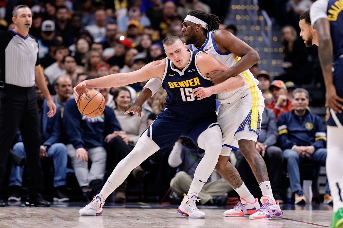 Nov 8, 2023; Denver, Colorado, USA; Denver Nuggets center Nikola Jokic (15) controls the ball under pressure from Golden State Warriors forward Kevon Looney (5) in the first quarter at Ball Arena. Mandatory Credit: Isaiah J. Downing-USA TODAY Sports