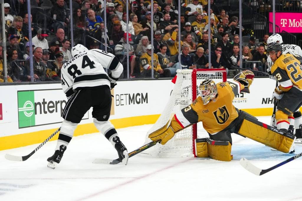 Nov 8, 2023; Las Vegas, Nevada, USA; Vegas Golden Knights goaltender Adin Hill (33) deflects the puck away from Los Angeles Kings defenseman Vladislav Gavrikov (84) during the first period at T-Mobile Arena. Mandatory Credit: Stephen R. Sylvanie-USA TODAY Sports