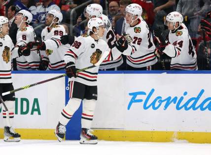 Nov 9, 2023; Tampa, Florida, USA; Chicago Blackhawks center Connor Bedard (98) is congratulated after he scored a goal against the Tampa Bay Lightning during the first period at Amalie Arena. Mandatory Credit: Kim Klement Neitzel-USA TODAY Sports
