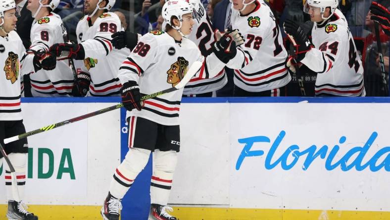 Nov 9, 2023; Tampa, Florida, USA; Chicago Blackhawks center Connor Bedard (98) is congratulated after he scored a goal against the Tampa Bay Lightning during the first period at Amalie Arena. Mandatory Credit: Kim Klement Neitzel-USA TODAY Sports