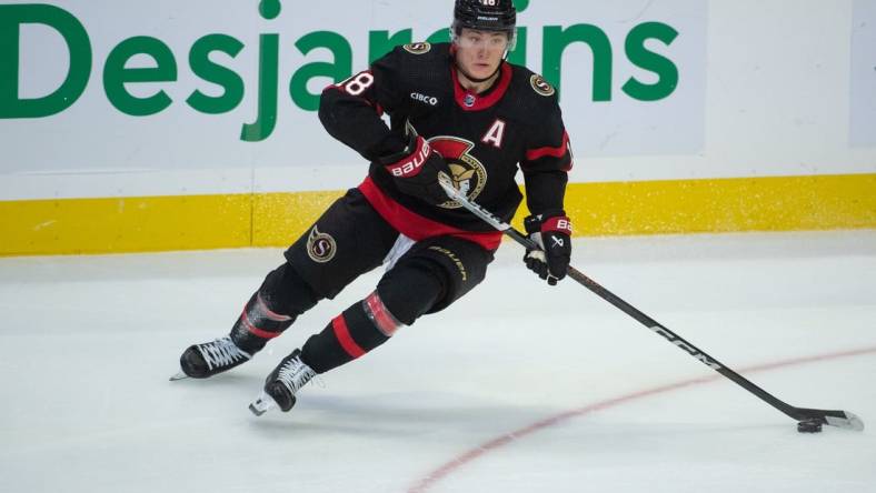 Nov 9, 2023; Ottawa, Ontario, CAN; Ottawa Senators center Tim Stutzle (18) skates with the puck in the third period against the Vancouver Canucks at the Canadian Tire Centre. Mandatory Credit: Marc DesRosiers-USA TODAY Sports