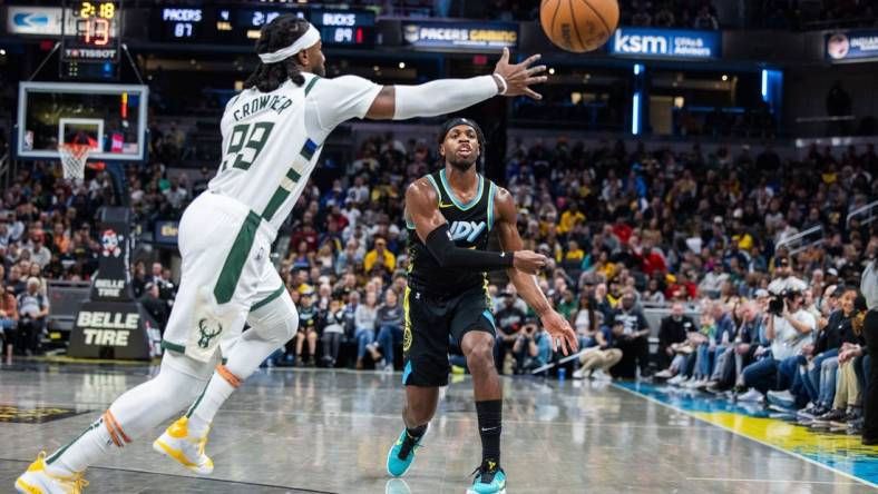 Nov 9, 2023; Indianapolis, Indiana, USA; Indiana Pacers guard Buddy Hield (7) passes the ball while Milwaukee Bucks forward Jae Crowder (99) defends in the second half at Gainbridge Fieldhouse. Mandatory Credit: Trevor Ruszkowski-USA TODAY Sports