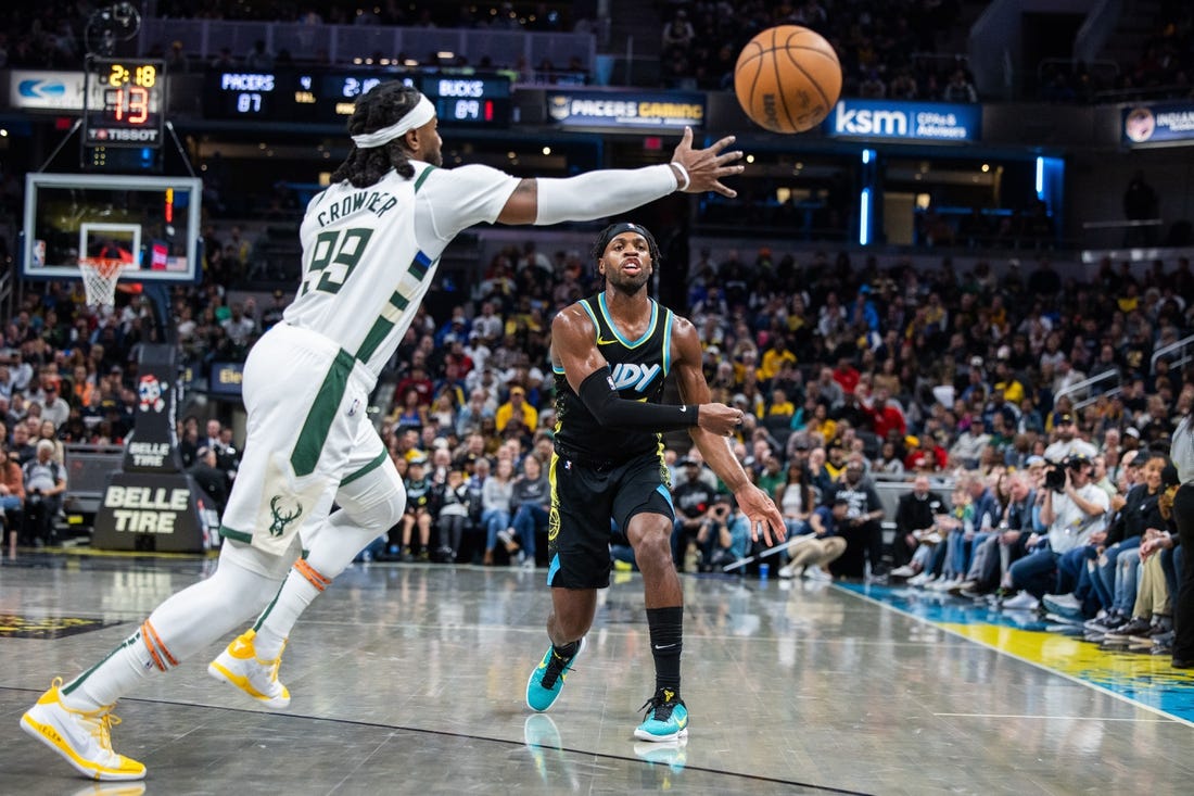 Nov 9, 2023; Indianapolis, Indiana, USA; Indiana Pacers guard Buddy Hield (7) passes the ball while Milwaukee Bucks forward Jae Crowder (99) defends in the second half at Gainbridge Fieldhouse. Mandatory Credit: Trevor Ruszkowski-USA TODAY Sports