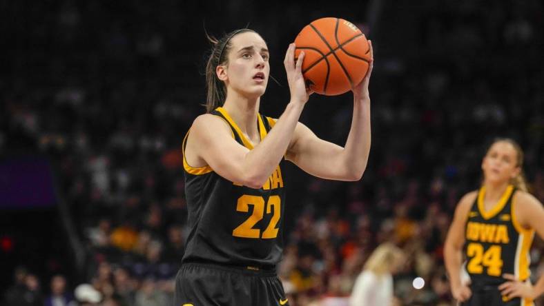 Nov 9, 2023; Charlotte, North Carolina, USA; Iowa Hawkeyes guard Caitlin Clark (22) sets up for a free throw during the second half against the Virginia Tech Hokies at Spectrum Center. Mandatory Credit: Jim Dedmon-USA TODAY Sports