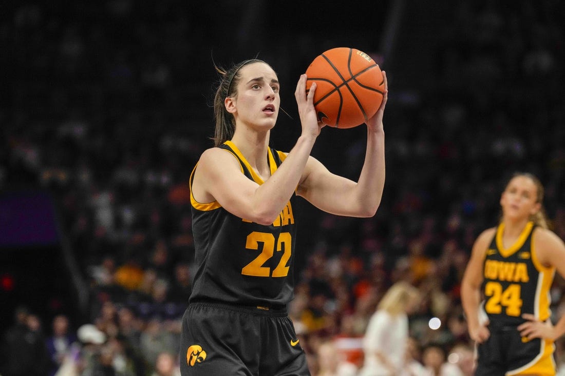 Nov 9, 2023; Charlotte, North Carolina, USA; Iowa Hawkeyes guard Caitlin Clark (22) sets up for a free throw during the second half against the Virginia Tech Hokies at Spectrum Center. Mandatory Credit: Jim Dedmon-USA TODAY Sports