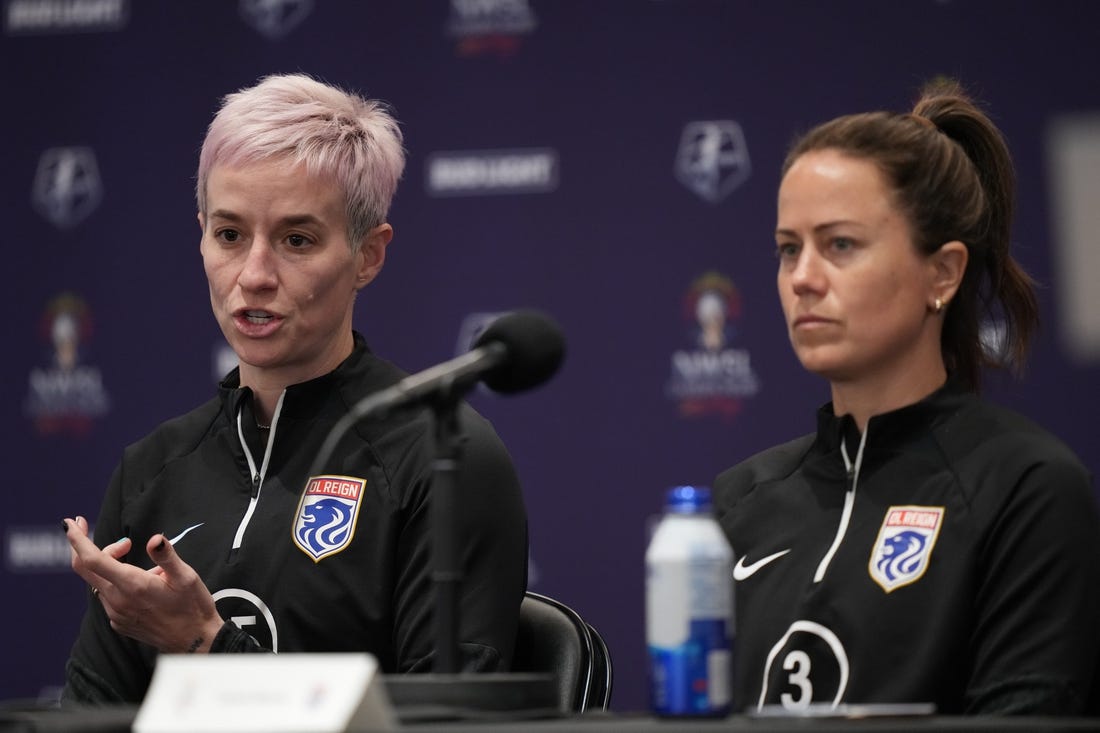 Nov 10, 2023; San Diego, California, USA; OL Reign forward Megan Rapinoe (15) speaks alongside defender Lauren Barnes (3) during a press conference at Snapdragon Stadium. Mandatory Credit: Kyle Terada-USA TODAY Sports