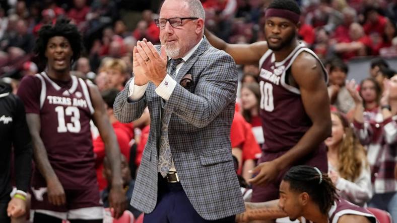 Nov 10, 2023; Columbus, Ohio, USA; Texas A&M Aggies head coach Buzz Williams applauds his team during the first half of the NCAA basketball game against the Ohio State Buckeyes at Value City Arena.