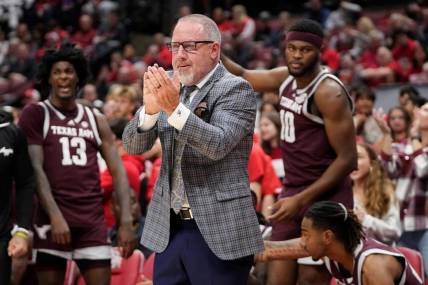 Nov 10, 2023; Columbus, Ohio, USA; Texas A&M Aggies head coach Buzz Williams applauds his team during the first half of the NCAA basketball game against the Ohio State Buckeyes at Value City Arena.