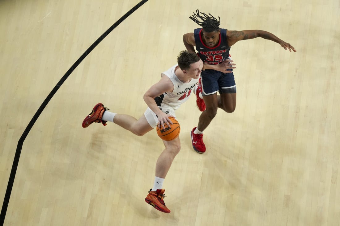 Nov 10, 2023; Cincinnati, Ohio, USA;  Cincinnati Bearcats guard Simas Lukosius (41) drives to the basket against Detroit Mercy Titans guard Marcus Tankersley (35) in the first half at Fifth Third Arena. Mandatory Credit: Aaron Doster-USA TODAY Sports