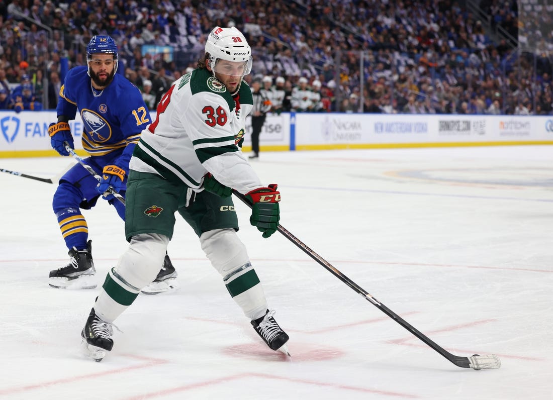 Nov 10, 2023; Buffalo, New York, USA;  Buffalo Sabres left wing Jordan Greenway (12) watches as Minnesota Wild right wing Ryan Hartman (38) drops a pass during the first period at KeyBank Center. Mandatory Credit: Timothy T. Ludwig-USA TODAY Sports