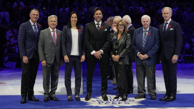 Nov 10, 2023; Toronto, Ontario, CAN; Hockey Hall of Fame Class of 2023 inductees Pierre Turgeon, Mike Vernon, Caroline Ouellette, Henrik Lundqvist, Coco Lacroix for her husband Pierre , Ken Hitchcock, and Tom Barrasso (left to right) before the start of the game between the Calgary Flames and Toronto Maple Leafs  at Scotiabank Arena. Mandatory Credit: John E. Sokolowski-USA TODAY Sports