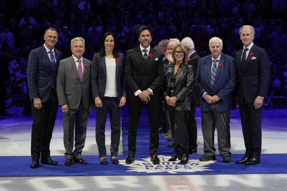 Nov 10, 2023; Toronto, Ontario, CAN; Hockey Hall of Fame Class of 2023 inductees Pierre Turgeon, Mike Vernon, Caroline Ouellette, Henrik Lundqvist, Coco Lacroix for her husband Pierre , Ken Hitchcock, and Tom Barrasso (left to right) before the start of the game between the Calgary Flames and Toronto Maple Leafs  at Scotiabank Arena. Mandatory Credit: John E. Sokolowski-USA TODAY Sports