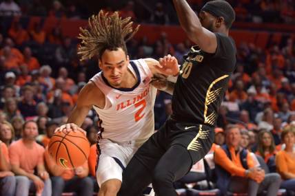 Nov 10, 2023; Champaign, Illinois, USA;  Illinois Fighting Illini guard Dra Gibbs-Lawhorn (2) drives against Oakland Golden Grizzlies guard DQ Cole (10) during the first half at State Farm Center. Mandatory Credit: Ron Johnson-USA TODAY Sports