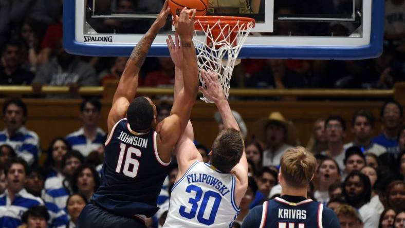 Nov 10, 2023; Durham, North Carolina, USA;  Arizona Wildcats forward Keshad Johnson (16) tips the ball into the basket in front of Duke Blue Devils center Kyle Filipowski(30)during the second half at Cameron Indoor Stadium. Mandatory Credit: Rob Kinnan-USA TODAY Sports