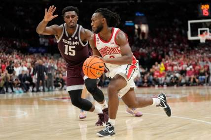Nov 10, 2023; Columbus, Ohio, USA; Ohio State Buckeyes guard Bruce Thornton (2) drives past Texas A&M Aggies forward Henry Coleman III (15) during the second half of the NCAA basketball game at Value City Arena. Ohio State lost 73-66.