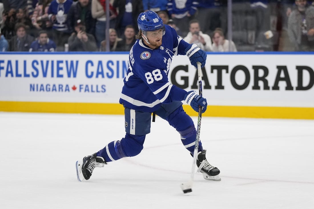 Nov 10, 2023; Toronto, Ontario, CAN; Toronto Maple Leafs forward William Nylander (88) shoots the puck against the Calgary Flames during the overtime shootout at Scotiabank Arena. Mandatory Credit: John E. Sokolowski-USA TODAY Sports