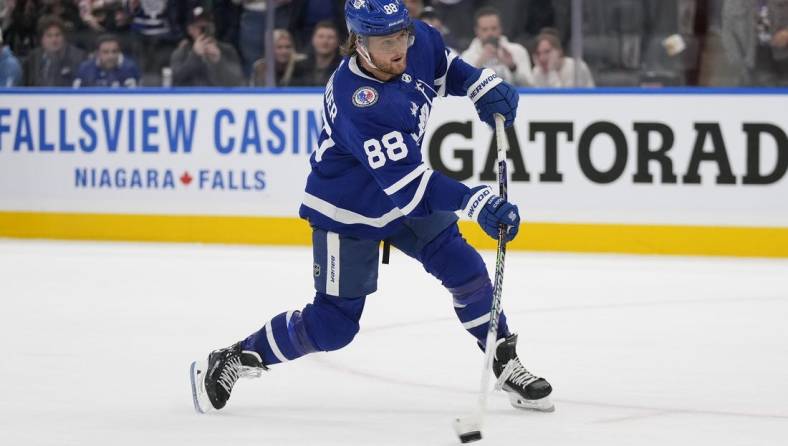 Nov 10, 2023; Toronto, Ontario, CAN; Toronto Maple Leafs forward William Nylander (88) shoots the puck against the Calgary Flames during the overtime shootout at Scotiabank Arena. Mandatory Credit: John E. Sokolowski-USA TODAY Sports