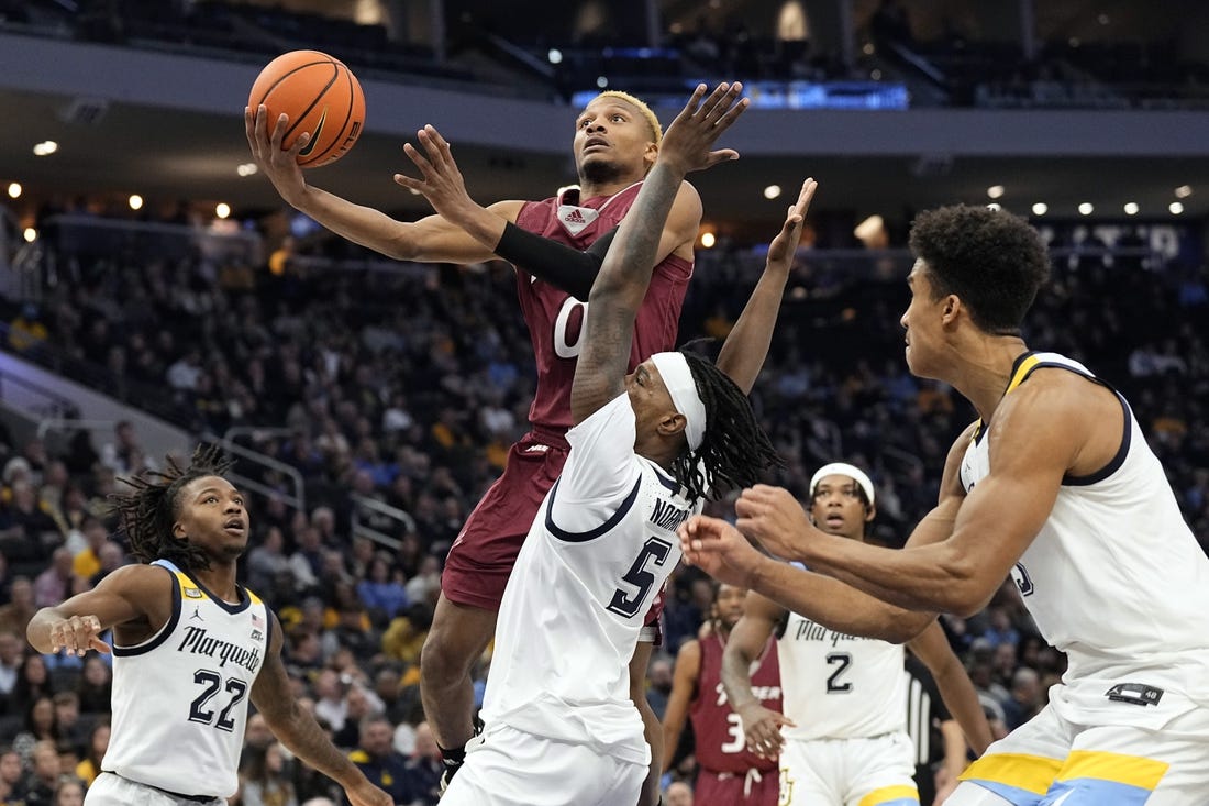 Nov 10, 2023; Milwaukee, Wisconsin, USA;  Rider Broncs guard D.J. Dudley (0) shoots against Marquette Golden Eagles guard Tre Norman (5) during the second half at Fiserv Forum. Mandatory Credit: Jeff Hanisch-USA TODAY Sports