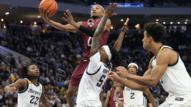 Nov 10, 2023; Milwaukee, Wisconsin, USA;  Rider Broncs guard D.J. Dudley (0) shoots against Marquette Golden Eagles guard Tre Norman (5) during the second half at Fiserv Forum. Mandatory Credit: Jeff Hanisch-USA TODAY Sports