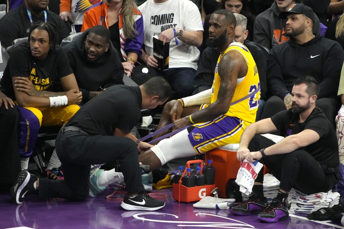 Nov 10, 2023; Phoenix, Arizona, USA; Los Angeles Lakers forward LeBron James (23) gets medical attention in a timeout against the Phoenix Suns in the first half at Footprint Center. Mandatory Credit: Rick Scuteri-USA TODAY Sports