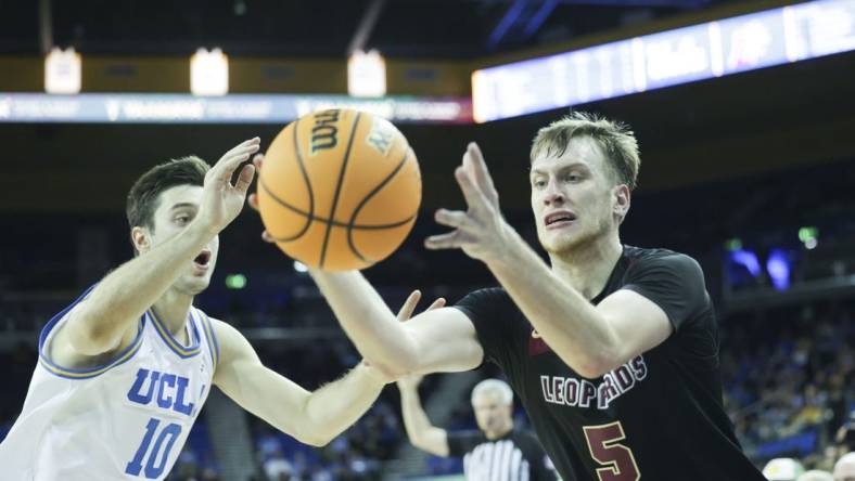 Nov 10, 2023; Los Angeles, California, USA; Lafayette guard Eric Sondberg (5) catches the ball as UCLA guard Lazar Stefanovic (10) defends in the second half at Pauley Pavilion presented by Wescom. Mandatory Credit: Yannick Peterhans-USA TODAY Sports