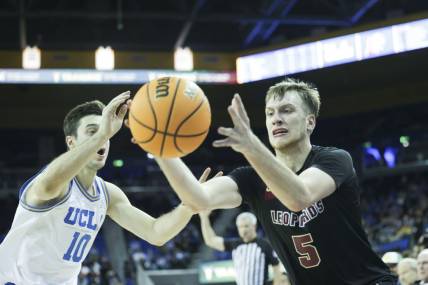 Nov 10, 2023; Los Angeles, California, USA; Lafayette guard Eric Sondberg (5) catches the ball as UCLA guard Lazar Stefanovic (10) defends in the second half at Pauley Pavilion presented by Wescom. Mandatory Credit: Yannick Peterhans-USA TODAY Sports