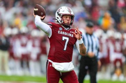 Nov 11, 2023; Columbia, South Carolina, USA; South Carolina Gamecocks quarterback Spencer Rattler (7) throws for a touchdown against the Vanderbilt Commodores in the first quarter at Williams-Brice Stadium. Mandatory Credit: Jeff Blake-USA TODAY Sports