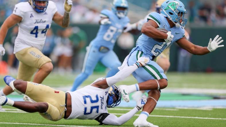 Nov 11, 2023; New Orleans, Louisiana, USA; Tulsa Golden Hurricane safety Jaise Oliver (25) tries to tackler Tulane Green Wave running back Makhi Hughes (21) in first quarter action at Yulman Stadium. Mandatory Credit: Matthew Dobbins-USA TODAY Sports