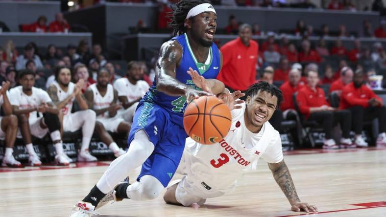 Nov 11, 2023; Houston, Texas, USA; Texas A&M-CC Islanders guard Lance-Amir Paul (40) drives with the ball as Houston Cougars guard Ramon Walker Jr. (3) defends during the first half at Fertitta Center. Mandatory Credit: Troy Taormina-USA TODAY Sports