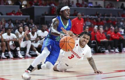 Nov 11, 2023; Houston, Texas, USA; Texas A&M-CC Islanders guard Lance-Amir Paul (40) drives with the ball as Houston Cougars guard Ramon Walker Jr. (3) defends during the first half at Fertitta Center. Mandatory Credit: Troy Taormina-USA TODAY Sports