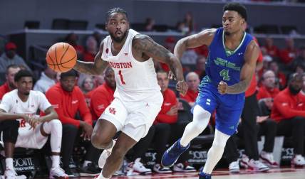 Nov 11, 2023; Houston, Texas, USA; Houston Cougars guard Jamal Shead (1) looks to pass the ball as Texas A&M-CC Islanders guard Kam Parker (4) defends during the second half at Fertitta Center. Mandatory Credit: Troy Taormina-USA TODAY Sports