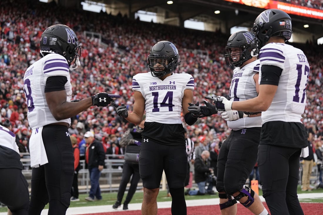 Nov 11, 2023; Madison, Wisconsin, USA;  Northwestern Wildcats wide receiver Cam Johnson (14) celebrates after scoring a touchdown during the second quarter against the Wisconsin Badgers at Camp Randall Stadium. Mandatory Credit: Jeff Hanisch-USA TODAY Sports