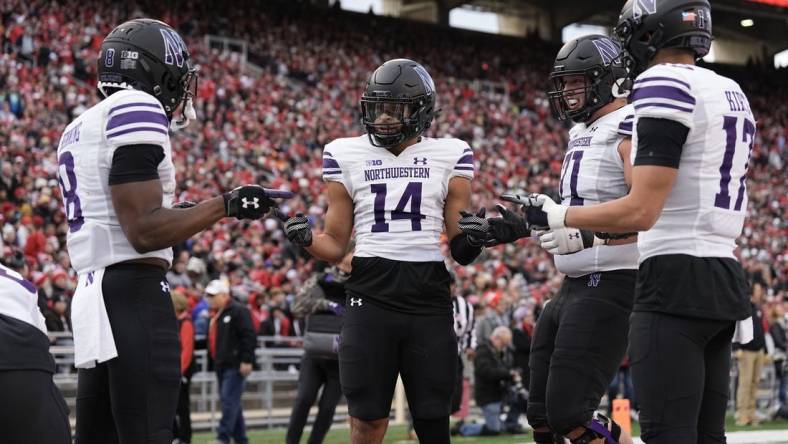 Nov 11, 2023; Madison, Wisconsin, USA;  Northwestern Wildcats wide receiver Cam Johnson (14) celebrates after scoring a touchdown during the second quarter against the Wisconsin Badgers at Camp Randall Stadium. Mandatory Credit: Jeff Hanisch-USA TODAY Sports