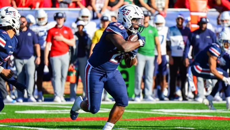 Nov 11, 2023; Lynchburg, Virginia, USA;  Liberty Flames running back Quinton Cooley (20) runs the ball in the third quarter at Williams Stadium. Mandatory Credit: Brian Bishop-USA TODAY Sports