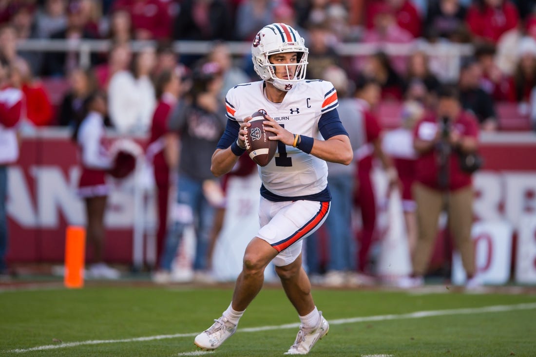 Nov 11, 2023; Fayetteville, Arkansas, USA;  Auburn Tigers quarterback Payton Thorne (1) rolls out to pass during the second quarter against the Arkansas Razorbacks at Donald W. Reynolds Razorback Stadium. Mandatory Credit: Brett Rojo-USA TODAY Sports