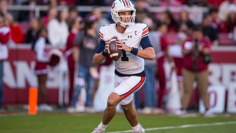 Nov 11, 2023; Fayetteville, Arkansas, USA;  Auburn Tigers quarterback Payton Thorne (1) rolls out to pass during the second quarter against the Arkansas Razorbacks at Donald W. Reynolds Razorback Stadium. Mandatory Credit: Brett Rojo-USA TODAY Sports