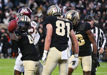 Nov 11, 2023; West Lafayette, Indiana, USA;  Purdue Boilermakers wide receiver Deion Burks (4) celebrates with tight end George Burhenn (81) and wide receiver Jaron Tibbs (13) after scoring a touchdown against the Minnesota Golden Gophers during the second half at Ross-Ade Stadium. Mandatory Credit: Robert Goddin-USA TODAY Sports
