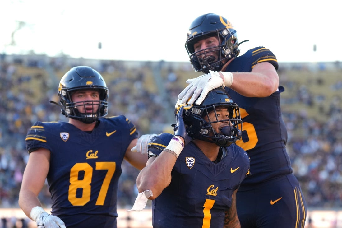 Nov 11, 2023; Berkeley, California, USA; California Golden Bears running back Jaydn Ott (1) gestures towards the Washington State Cougars fan section after scoring a touchdown while being congratulated by tight end Jeffrey Johnson (right) and tight end Jack Endries (87) during the fourth quarter at California Memorial Stadium. Mandatory Credit: Darren Yamashita-USA TODAY Sports